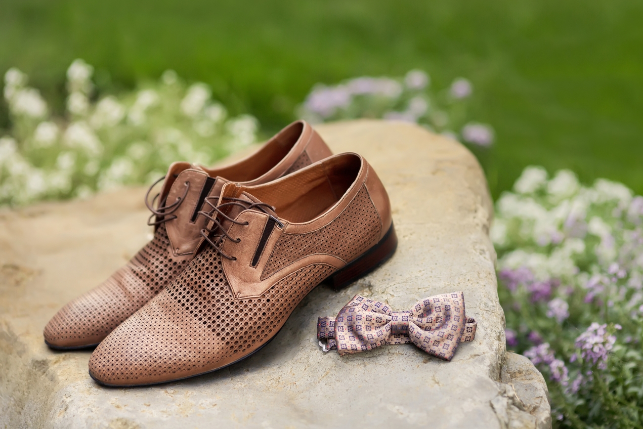 Colección de zapatos de hombre imprescindibles alineados en un armario moderno, mostrando variedad de estilos y materiales